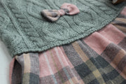 Close up to show knit sweater in green and pink flannel skirt for dog