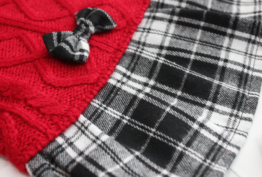 Red cable knit sweater for dog, close up of flannel bow and skirt in black and white.