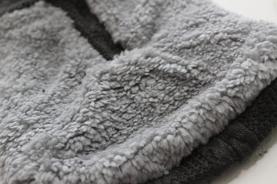 close up of long fleece inside dog sweater in gray