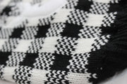close up of buffalo check dog sweater, showing knitted material.