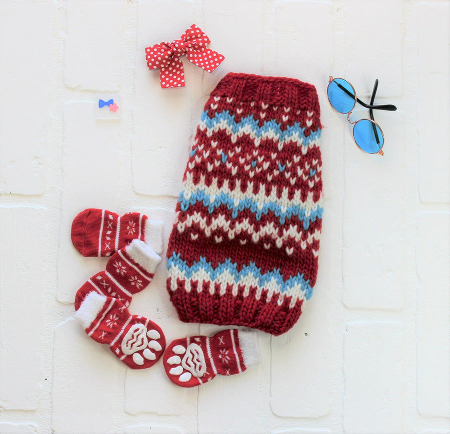Red and Blue knitted pet sweater, flat lay showing design with dog accessories