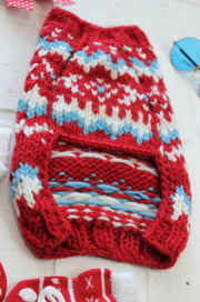 Close up of knitting in dog sweater, showing inside and underside of sweater.