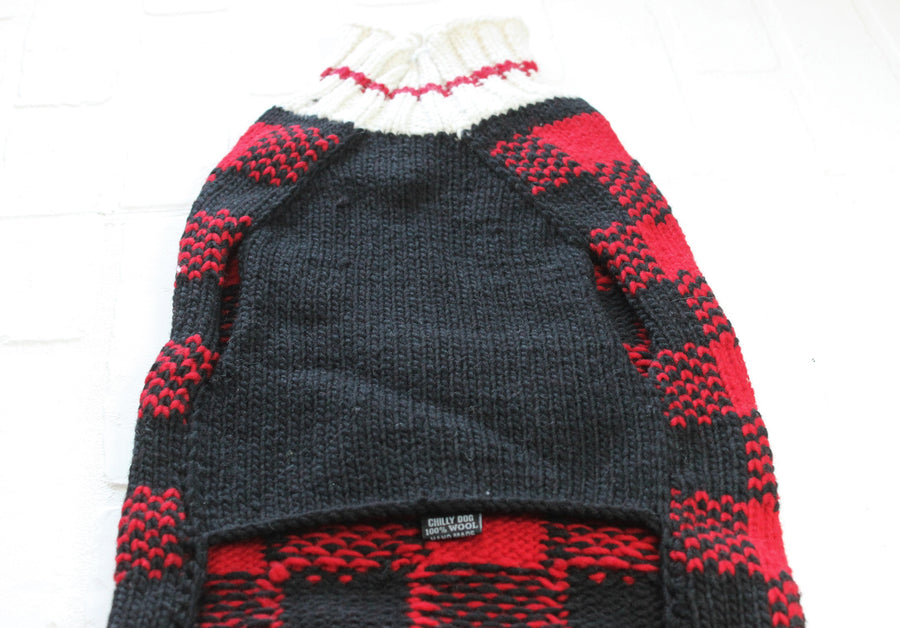 Underside of plaid pet sweater, handmade of tightly knit wool